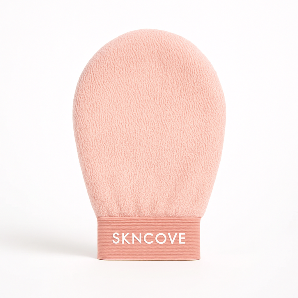 Pink exfoliating glove with 'SKNCOVE' branding on a white background