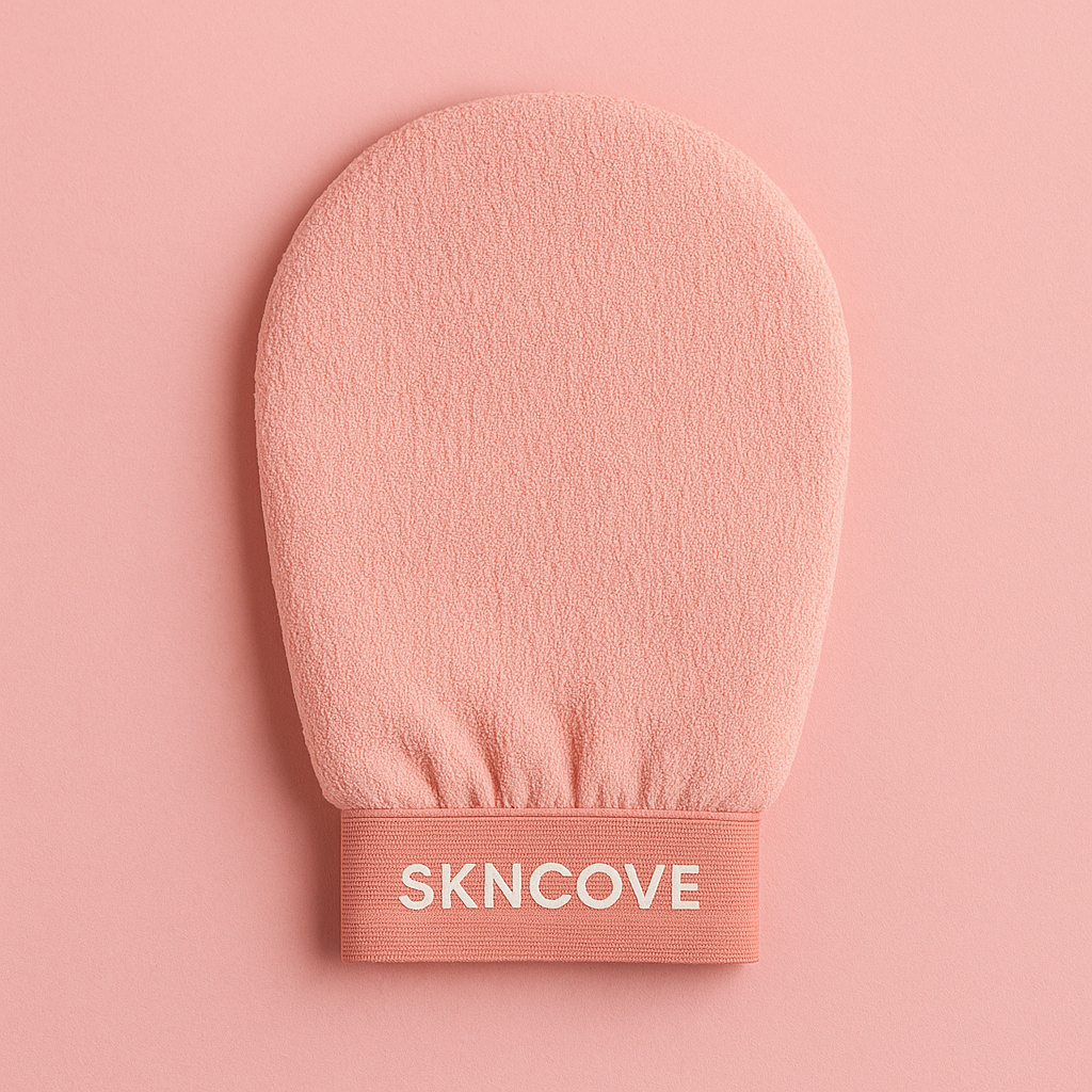 Pink exfoliating glove with 'SKNCOVE' branding on a pink background
