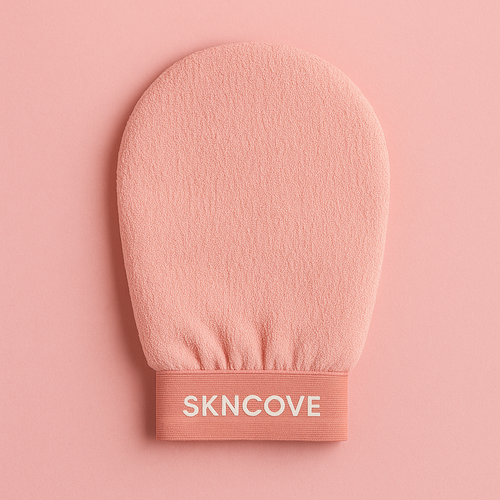 Pink exfoliating glove with 'SKNCOVE' branding on a pink background