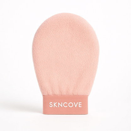 Pink exfoliating glove with 'SKNCOVE' branding on a white background