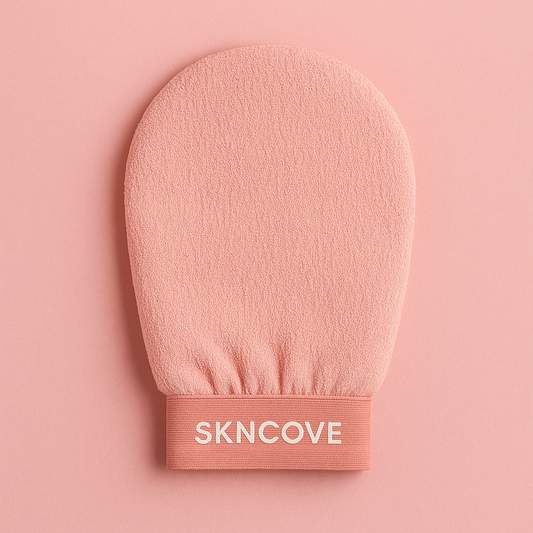 Pink exfoliating glove with 'SKNCOVE' branding on a pink background